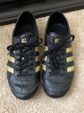 adidas Women’s Black Sneakers with Gold Stripes